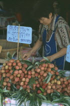 Streetmarket vendor selling lychees.