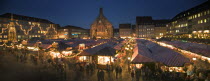 Panoramic view of the Christmas Market in Hauptmarkt with The Frauenkirche behind.  FestiveAdventYuletideTravelHolidaysPanorama