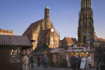 The Christmas Market in Hauptmarkt with The Frauenkirche behind.Christkindlesmarkt  FestiveAdventYuletideTravelHoliday