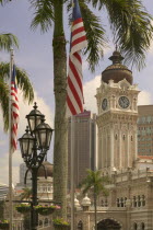 The Sultan Abdul Samad Building with palm tree  flag and lamp post in the foreground.  TourismTravelIconArchitectur