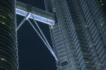 Detail of the Petronis Towers at night showing walkway between the two towers.  TravelArchitectureSkyscrapersIcon