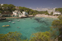 Cala Santany  View of the beach with boats on the clear water.MajorcaMediterraneanHolidaysTourismTravelBeachSeasideSun bathing