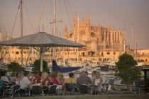 Palma de Mallorca  Cafe next to the port with the Cathedral behind.MajorcaMediterraneanHolidaysTourismTravelDiningDrinkingCafes