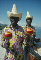 Musicians playing drum and maracas.