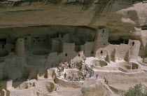 View of the Cliff Palace which is the largest Anasazi cliff dwelling with tourist group