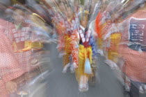 Maki Tsuchiya  9 years old  leads the "tekomae"  young girls proceeding the wagon pulled during Gion Matsuri wearing traditional Edo-era costumeRadial Blur.