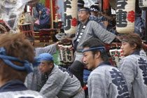 Men in traditional Edo-era costumes wait to pull their neighborhood dashi or wagon during Gion Matsuri