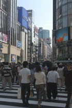 Ginza. Pedestrian crossing and view along Chuo-dori avenue at the intersection with Harumi-dori avenue