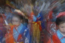 Girls aged 8-12 years old in traditional Edo-era costumes lead their neighborhoods dashi or wagon through the streets during Gion Matsuri. Radial blur.Festival Festival