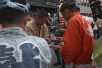 Gion Matsuri. Men in Edo-era costume  each specific to their neighborhood  exchange gifts before starting that days activities