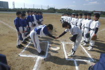 Toshiki Hagiwara  a 12 year old 6th grader  captain of Toujou Shonen Yakyu Club  shakes hand of Asahi Eagles captain before starting baseball game