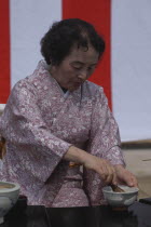 Licensed tea master Shikako Namba prepares "macha" green tea at a tea ceremony  senior citizen