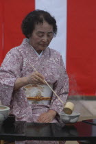 Licensed tea master Shikako Namba prepares green tea "macha" at a tea ceremony  senior citizen  wearing kimono