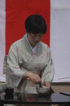 Licensed tea master Chiharu Koshikawa prepares green tea "macha" at a tea ceremony  wearing kimonoMR