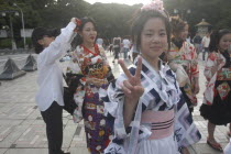 Harajuku. Members of Kyoto Rokumeikan relax after dancing at the entrance of Yoyogi Park dressed in half kimono costumes on Saturday afternoonall junior high and senior high school girls  13 - 19 yea...