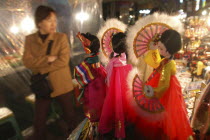 Namdaemun Market on a cold December night with customer looking at sounvenir dolls dressed in traditional Korean "hanbok"
