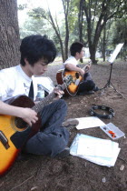 Yoyogi Park Harajuku. Yuki Nakagawa and Yousuke Koyama  both 15 years old  meet here on Saturday afternoons to practice guitars and sing