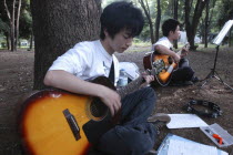 Yoyogi Park. Yuki Nakagawa and Yousuke Koyama  both 15 years old  meet here on Saturday afternoons to practice guitars and sing Harajuku