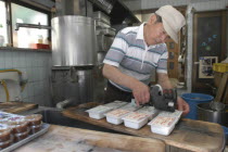 Yanak. Mr. Kyuhei Fukushima  68 years old  at work in his tofu shop
