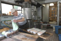 Yanak. Mr. Kyuhei Fukushima  68 years old  at work in his tofu shop
