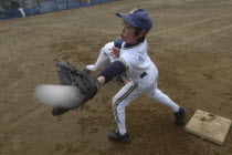 First baseman Satoshi Ui  12 year old 6th grader  reaches for a pick off throw. Member of Toujou Shonen Yakyu baseball Club