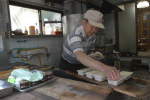 Yanak. Mr. Kyuhei Fukushima  68 years old  at work in his tofu shop