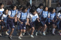 11-12 year old girls starting a 2 kilometer race which is part of the towns fitness festival5th and 6th grade