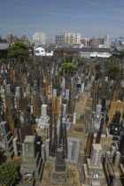 Yanaka. View over the cemetary of Shoyomei-ji Temple with closely surrounding buildings beyond