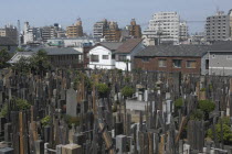 Yanaka. View over the cemetary of Shoyomei-ji Temple closely surrounded by buildings