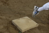 Little league players foot rounds first base during practice at Toujou Shonen Yakyu baseball Club practice.