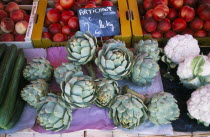 Samoens.  Artichokes on market stall also selling cauliflower  cucumber and nectarines.