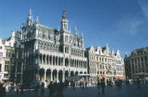 Grand Place lined with cafes with crowds of people.
