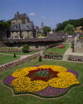 Hermine Castle walls and formal gardens with colourful flowerbed in the foreground.