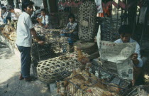 Market scene with ducks and chickens in small cages. Canton