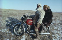 Mongol Ton up men on motorbike dressed in fur clothes.