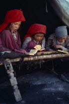 Kirghiz boys and girls reading the Koran.Girls and boys are educated together only while very young.