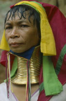 Woman from Karen tribe wearing traditional neck rings.  Refugee from Myanmar living in guarded village. Burma