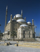 The Citadel. Mosque of Mohammed Ali. General view. White roof. Palm trees. blue sky.