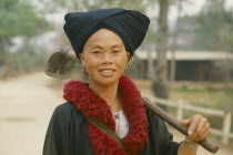 Yao tribeswoman with hoe over her shoulder