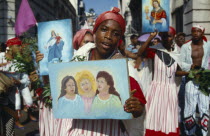 Woman holding religious imagery at a festival