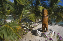 Carved wooden sacred statue standing on a stone basePolynesia