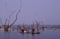 Family in a canoe on a lake in a flooded valley