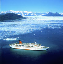 Cruise ship below glacier