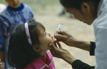 Primary school pupil receiving oral polio immunization.