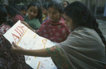 Women reading Aids awareness poster.