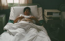 Pregnant mother in hospital bed attached to monitor