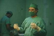 Doctor in theatre greens and sterile gloves ready to perform operation