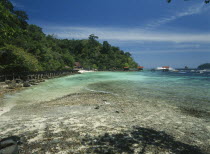 Pulau Paya marine national park with anchored tourist boats beyond the coral reef