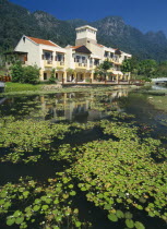 Oriental Village shopping complex at Burau Bay set around an artificial lake with Gunung Mat Cincang behind