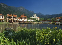 Oriental Village shopping complex at Burau Bay set around an artificial lake with Gunung Mat Cincang behind